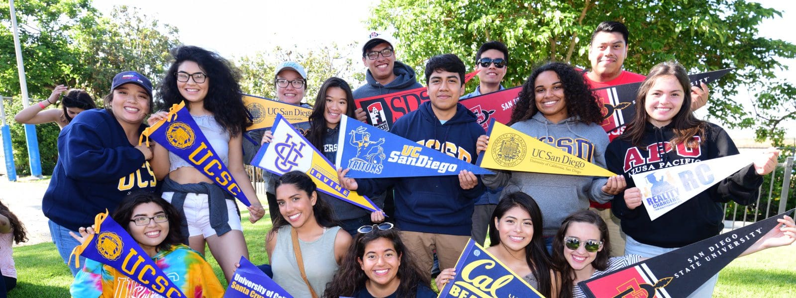college students standing in group with college pennant